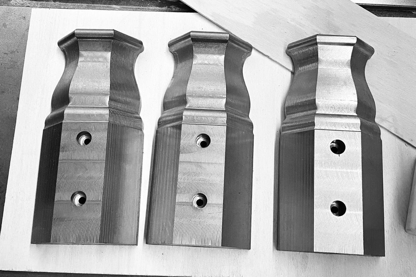 Three circa-1910 window muntin plinth recreations in iron, machined with molded profiles and mounting holes
